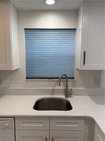 White diamond Quartz countertops with new stainless steel under-mount sink and gooseneck faucet. Custom cellular shades feature “easy” open close buttons.