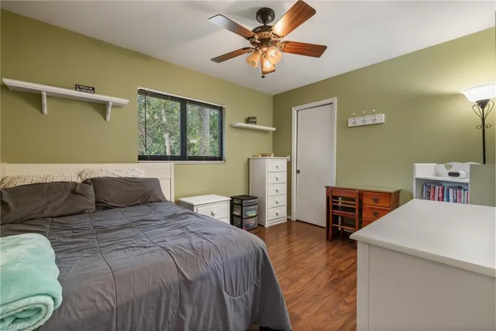 Bedroom with ceiling fan and dark hardwood / wood-style floors