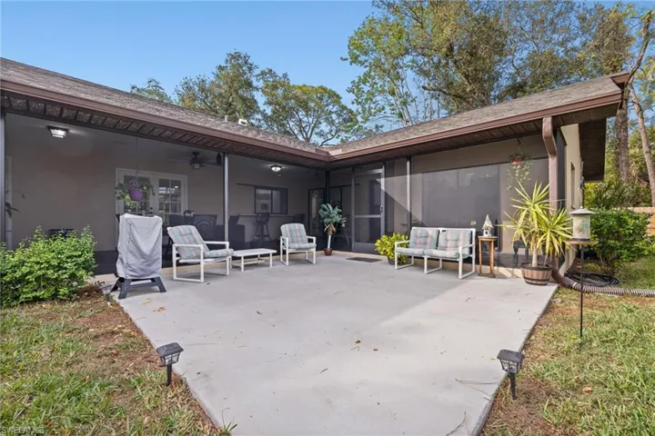 View of patio featuring outdoor lounge area, ceiling fan, and a sunroom