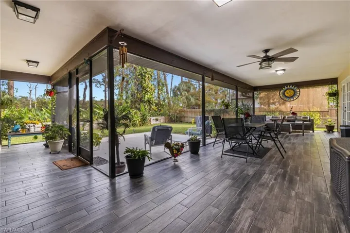 Sunroom / solarium featuring ceiling fan