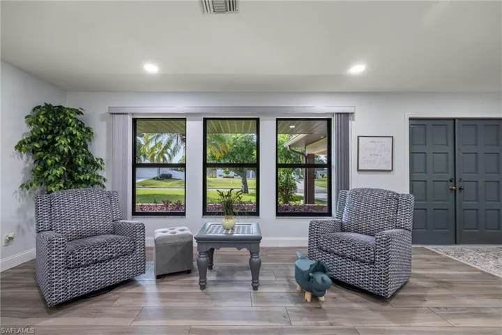 Sitting room with wood-type flooring