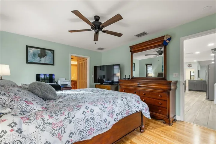 Bedroom featuring ceiling fan and light hardwood / wood-style flooring