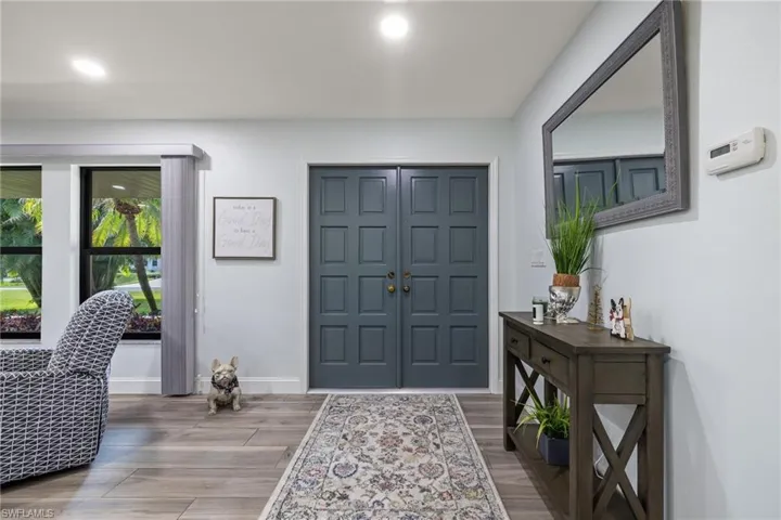 Entrance foyer with hardwood / wood-style floors