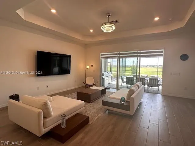 Living room featuring a raised ceiling and hardwood / wood-style floors