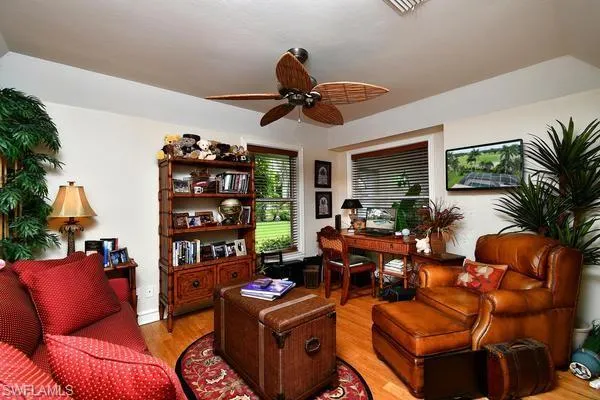 Office area with light wood-style flooring and ceiling fan