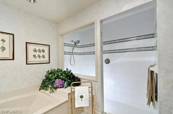 Bathroom with walk in shower and a bath