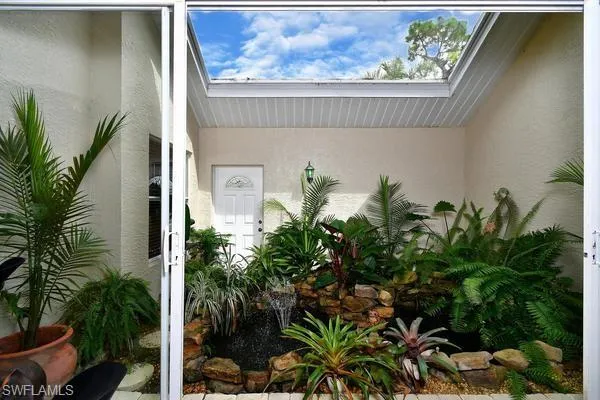 Property entrance with stucco siding