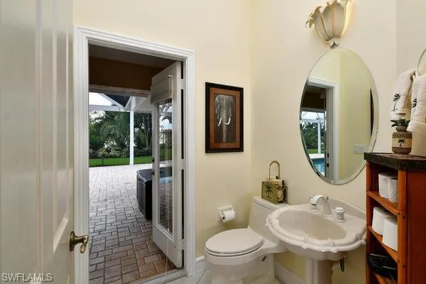 Half bath with toilet and baseboards