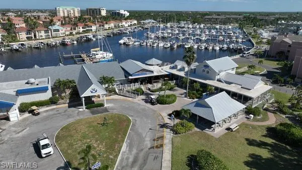 Drone / aerial view of numerous boat docks and a nearby body of water