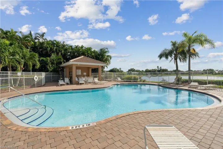 View of pool featuring a water view and a patio