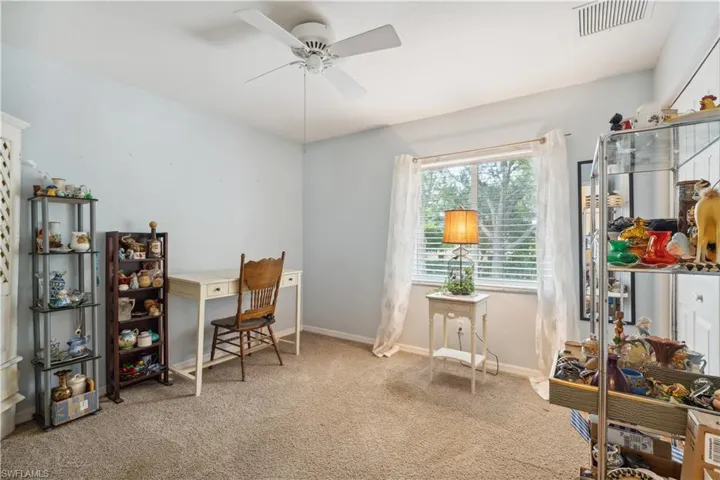 Home office featuring carpet flooring and ceiling fan