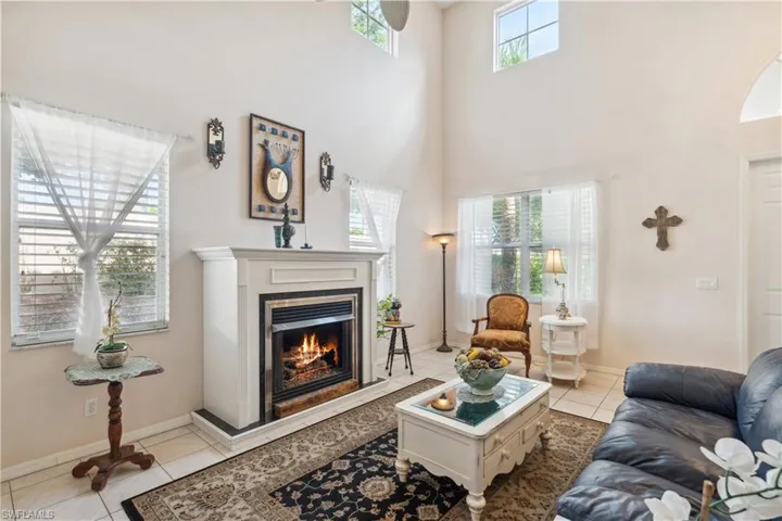 Living room featuring a towering ceiling and light tile patterned floors