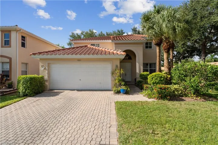 Mediterranean / spanish-style house with a garage