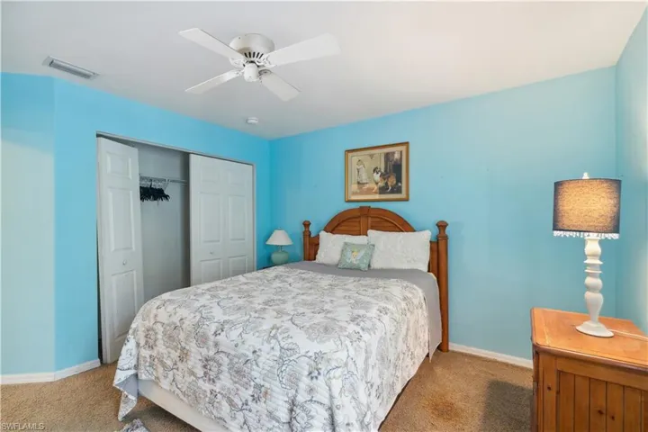 Bedroom featuring ceiling fan, a closet, and carpet