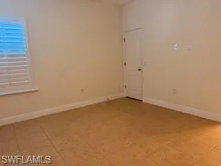 second masters  Room featuring tile flooring and neutral-toned walls