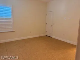 Second masters  Interior room with light-toned walls, tile flooring, and white baseboards