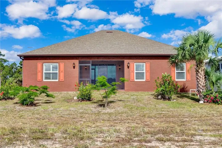 Stucco exterior with a hip roof and screened patio
