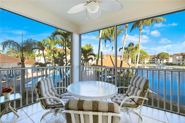 Sunroom / solarium featuring a water view and tile patterned flooring