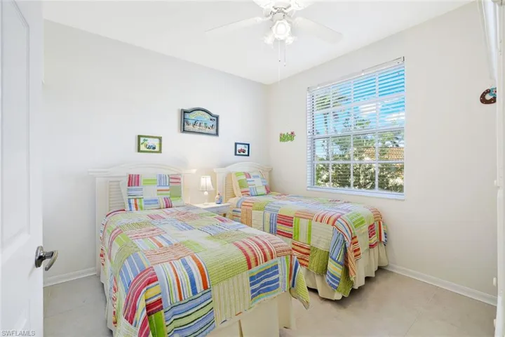 Bedroom featuring a ceiling fan and light tile patterned flooring