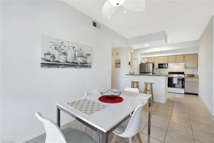 Dining area featuring light tile patterned floors and ceiling fan