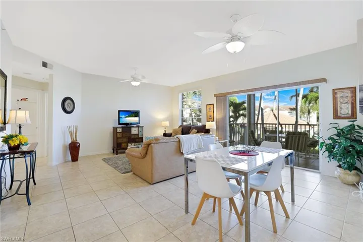 Dining area with a ceiling fan and light tile patterned floors