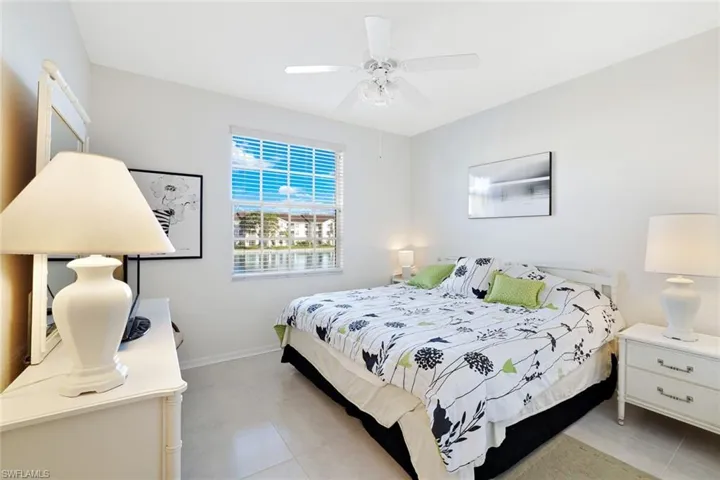 Bedroom with a ceiling fan and light tile patterned floors