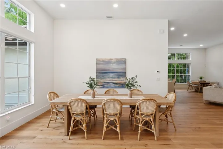 Dining area with recessed lighting and light wood finished floors
