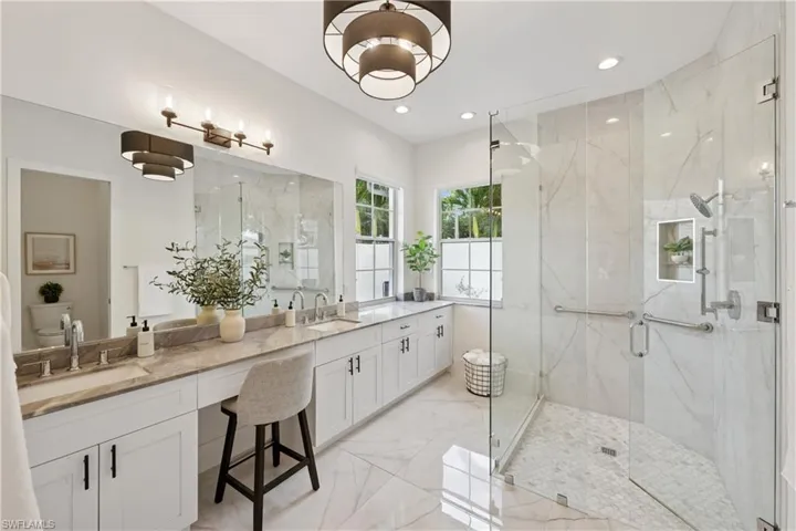 Full bathroom featuring a marble finish shower, marble finish floors, double vanity, and recessed lighting