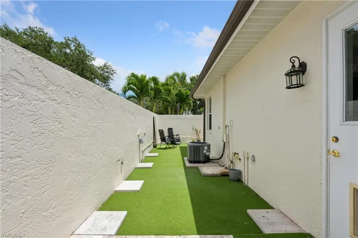 Side area off office and master bedroom. Dog run, exercise area, etc. Could be further developed as a patio space.