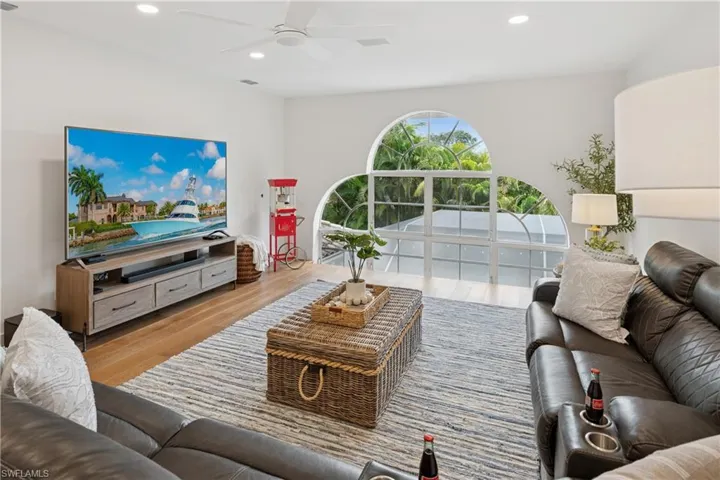 Living area featuring recessed lighting, ceiling fan, and wood finished floors