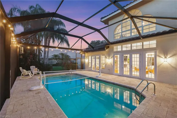 Outdoor pool featuring french doors, a patio area, and a lanai