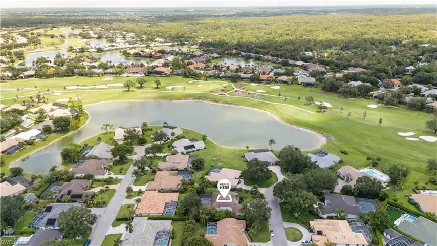Aerial overview of property's location with nearby suburban area and a nearby body of water
