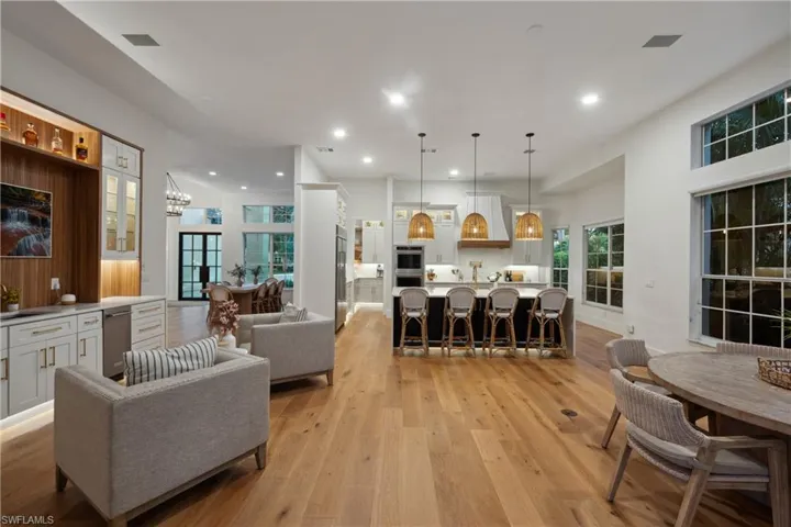 Living room featuring light wood finished floors, recessed lighting, and a chandelier