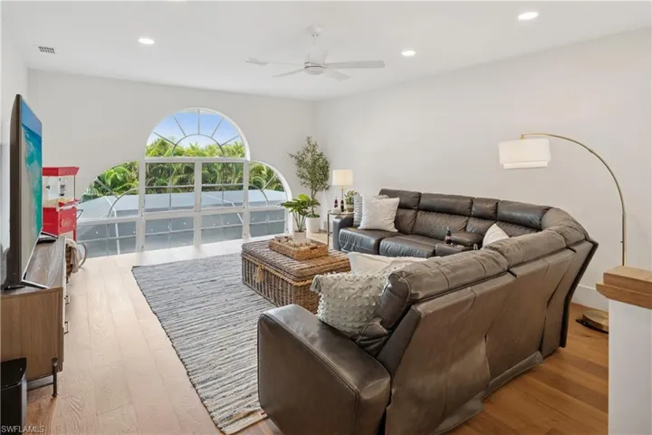 Living area featuring a ceiling fan, wood finished floors, and recessed lighting
