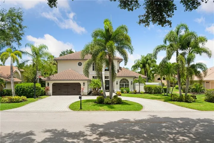 Mediterranean / spanish-style house featuring decorative driveway, an attached garage, stucco siding, and a tiled roof