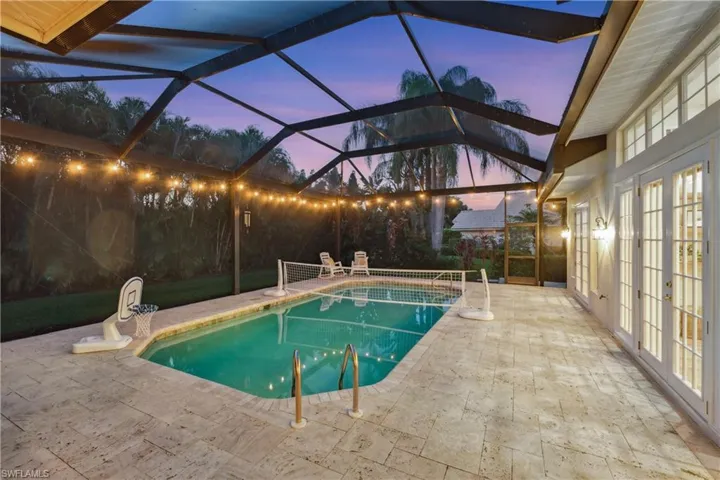 Outdoor pool featuring a patio, french doors, and glass enclosure