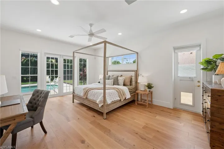 Bedroom featuring french doors, access to exterior, light wood-style floors, recessed lighting, and a ceiling fan