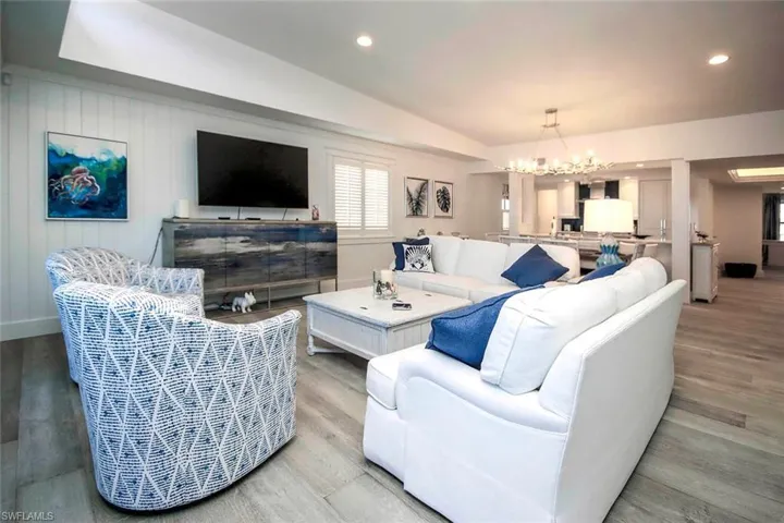 The mounted TV above a blue-toned media console integrates well with the room’s theme.
