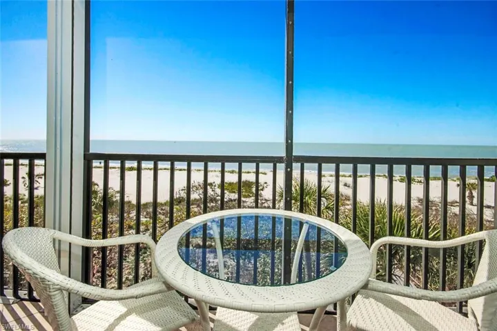 Balcony with a water view and a view of the beach