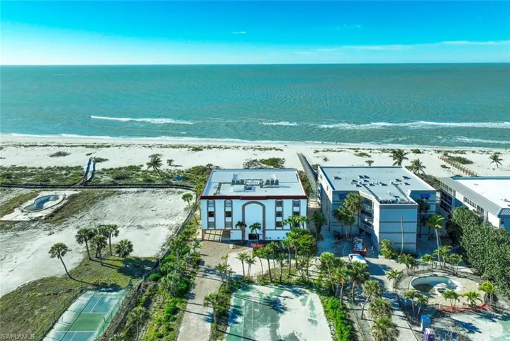 Aerial view featuring a beach view and a water view