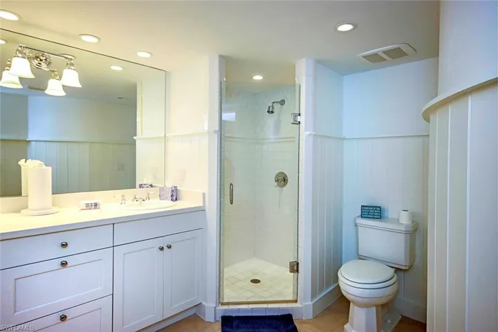 Full bath featuring stall shower, and double vanity