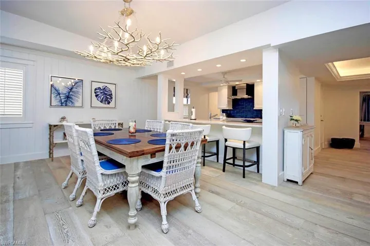 The statement chandelier mimics coral branches, enhancing the coastal theme while adding an eye-catching focal point.
