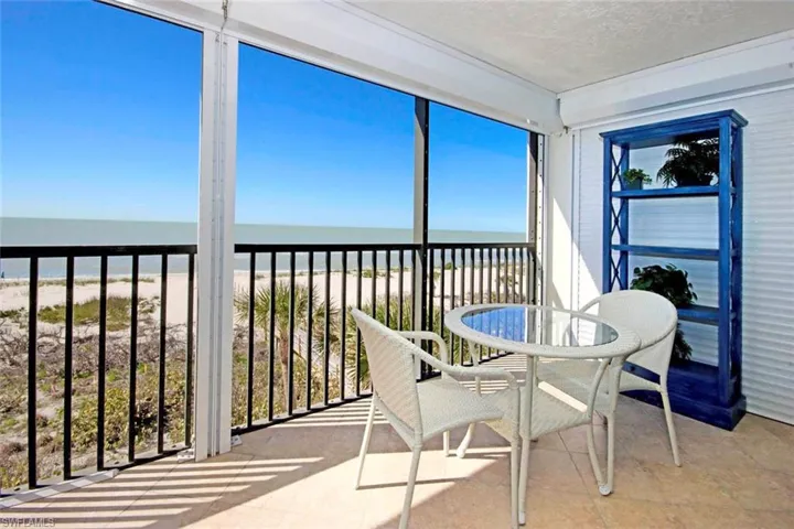 natural light, outdoor dining area, a view of the beach, and a water view