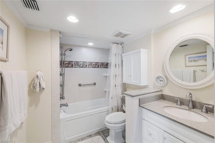 Your second vanity in the primary bathroom with relaxing tub.