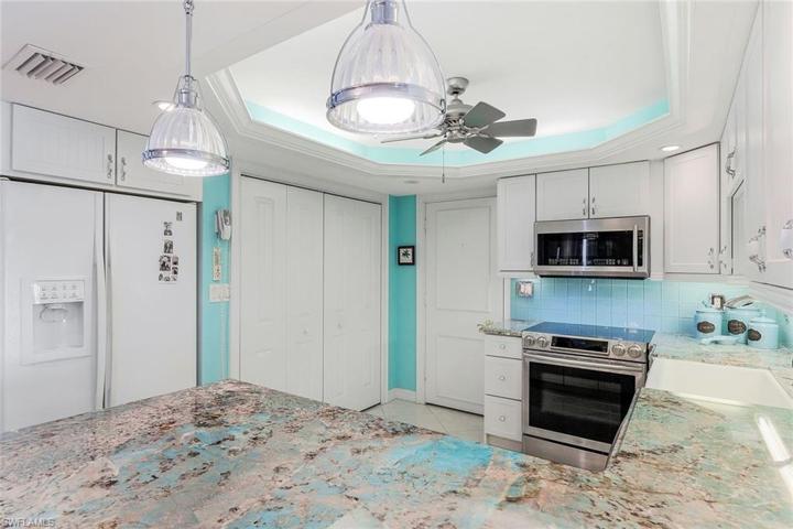 Direct access to your kitchen. You will notice the beautiful pendant lighting and your washer and dryer located behind those bifold doors!
