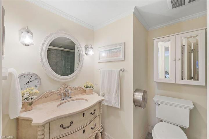 Guest bathroom with decorative vanity and tasteful sconce light fixtures!