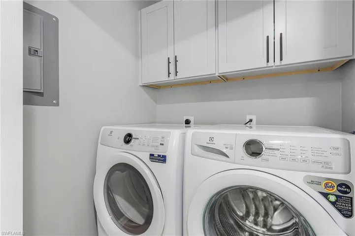 Washroom featuring cabinets, hookup for an electric dryer, and washer