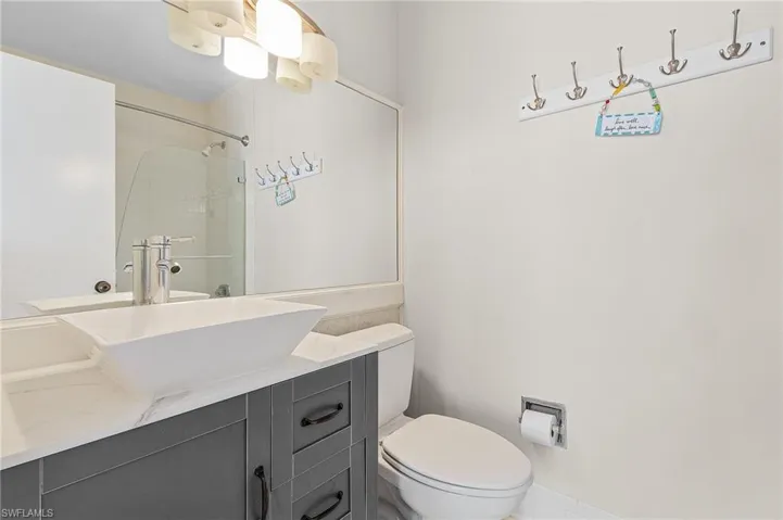 Guest Bathroom featuring oversized vanity and toilet and tub/shower