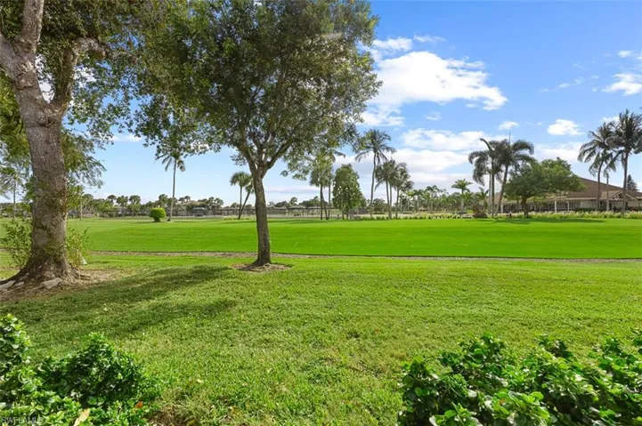 View of home's community featuring golf course view and a yard