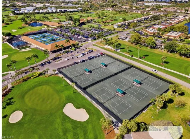 Bird's eye view of a golf course and a large body of water